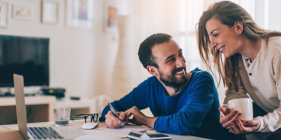 A couple checks on their money market account online.