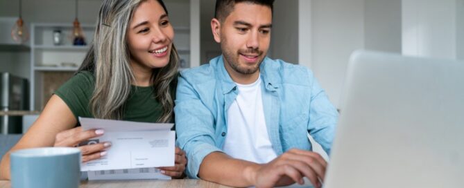 A couple checks on their joint bank account and pays bills.