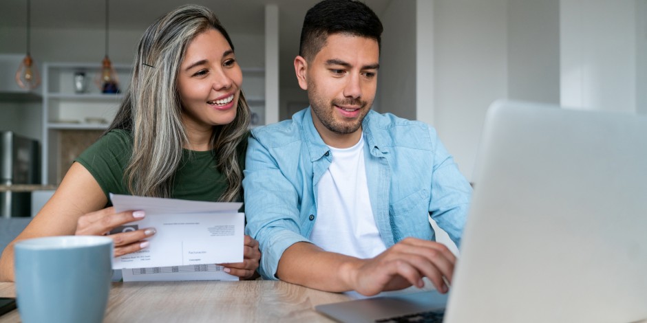 A couple checks on their joint bank account and pays bills.