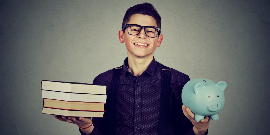 A college student balances his textbooks and a piggy bank.