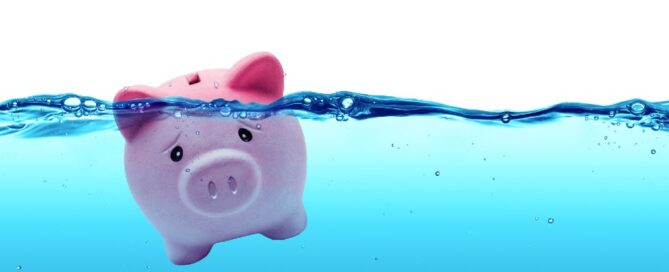 A piggy bank under water represents drowning in debt.