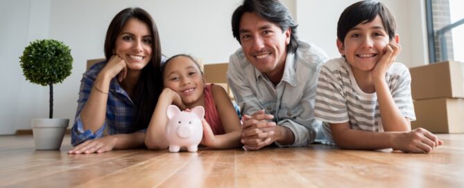 A Latino family pauses to reflect as they move into their new house.