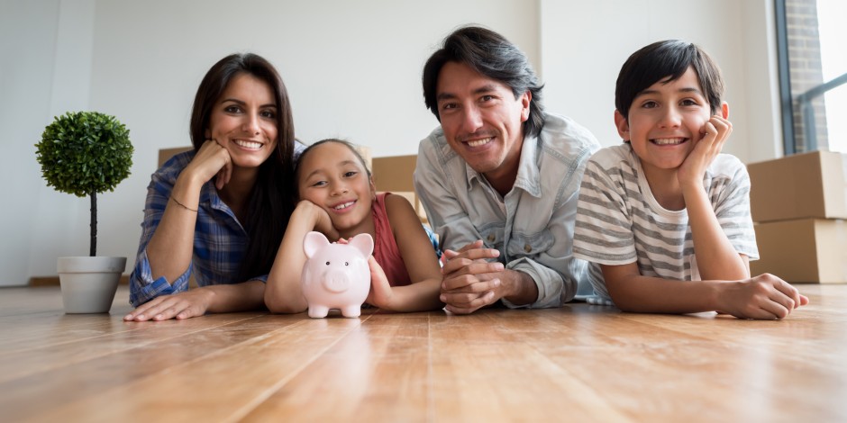 A Latino family pauses to reflect as they move into their new house.